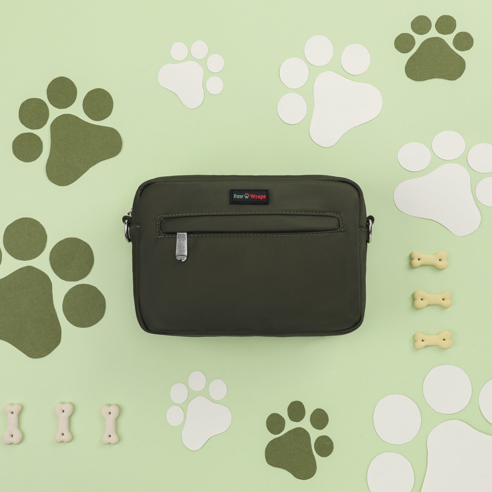 Olive green dog walking bag with paw prints and bone accents, stylish for small dogs