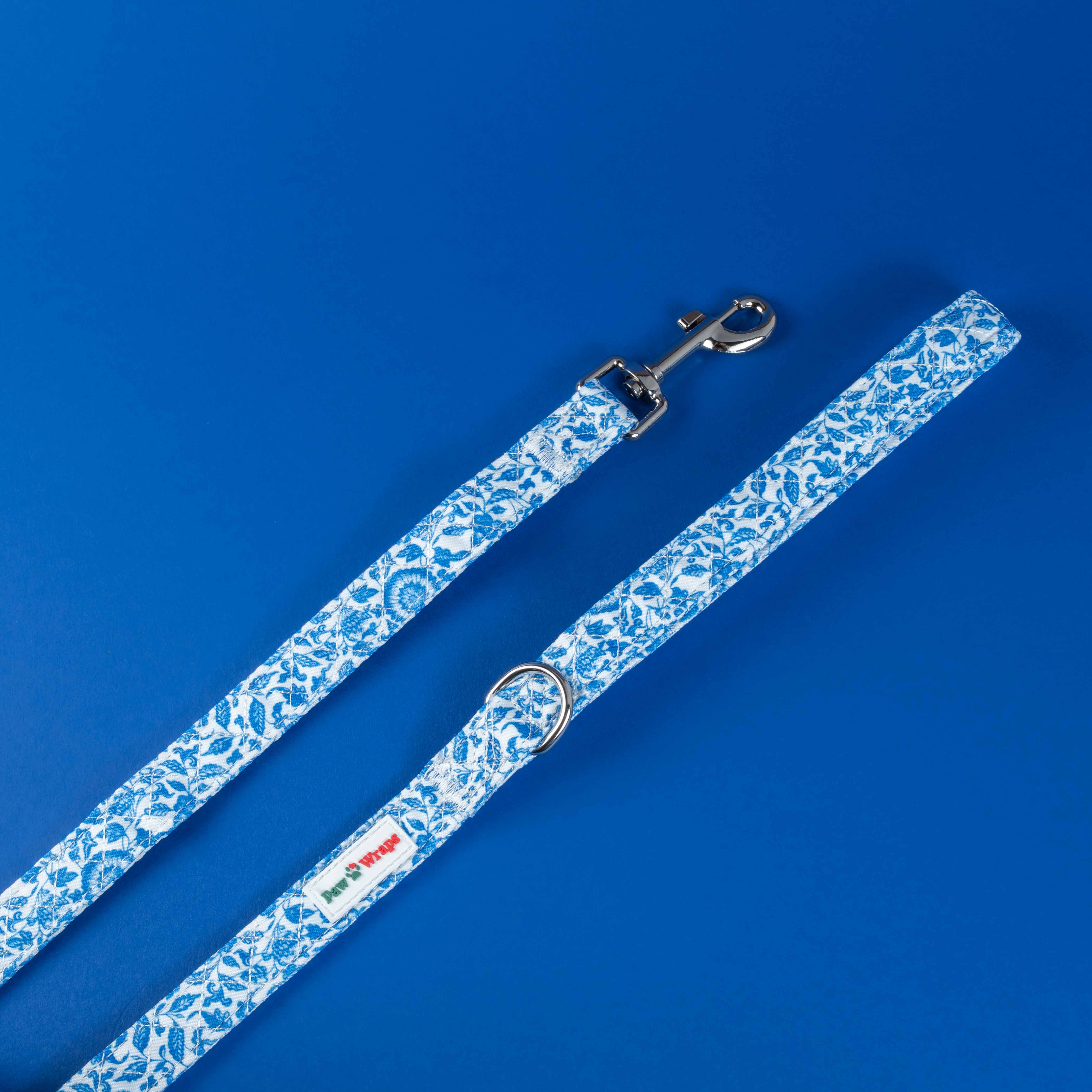 Blue floral dog leash with stylish pattern and metal clasp on vibrant blue background