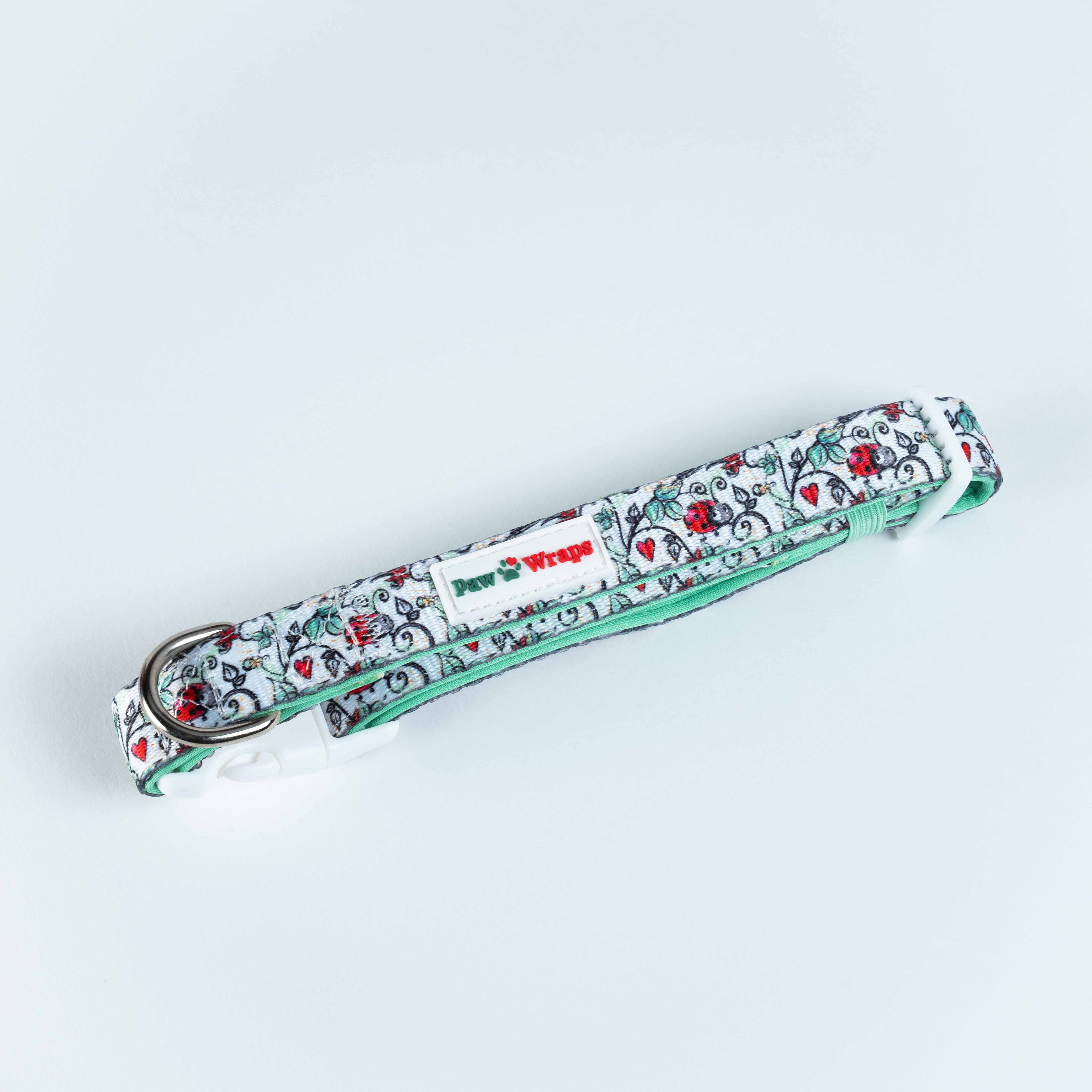 Floral pattern dog collar with mint green trim and Paw Wraps label, stylish pet accessory