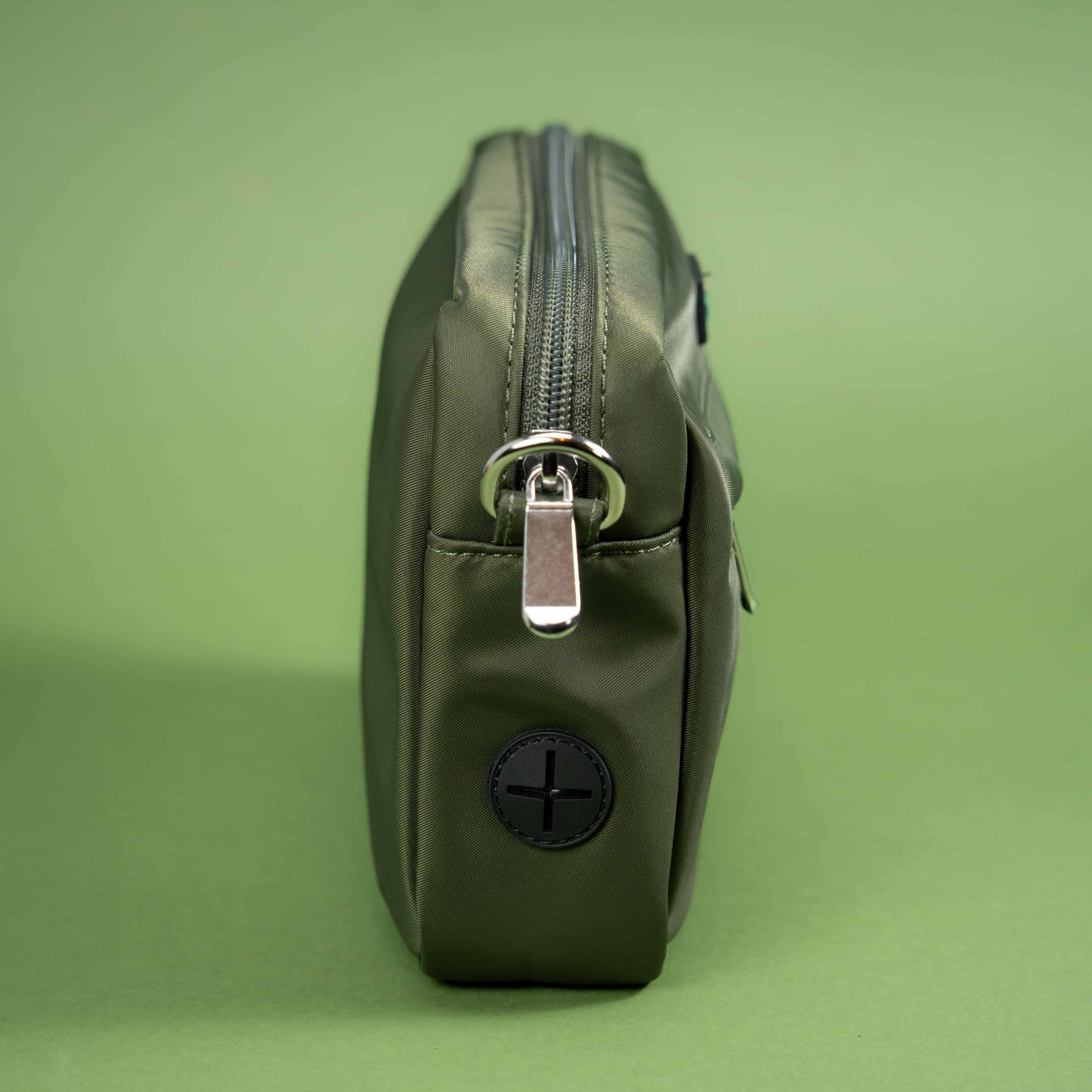 Olive green dog walking bag with zipper and metal clasp, stylish accessory for small dogs