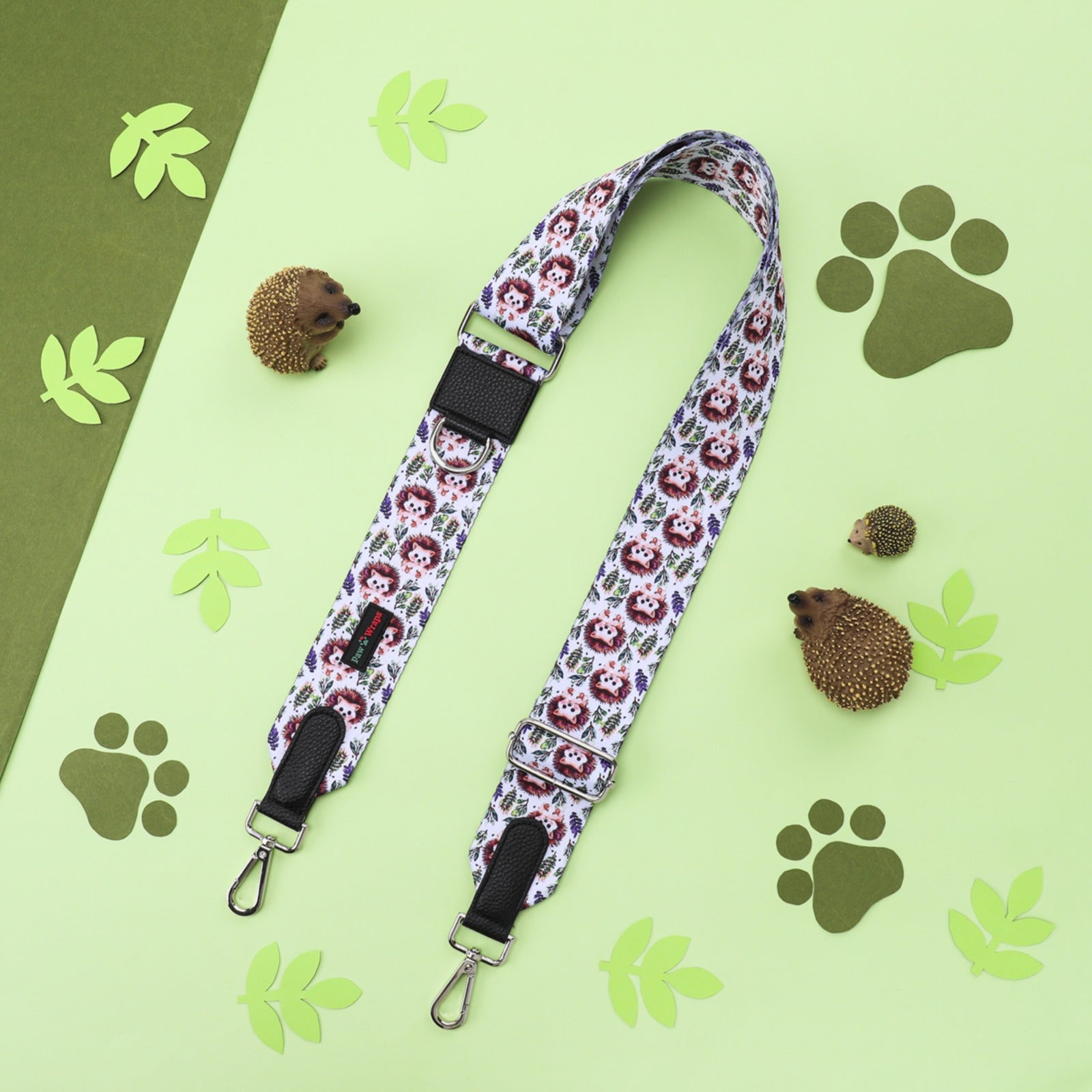 Cute hedgehog print dog lead with paw prints and green leaves on a pastel background