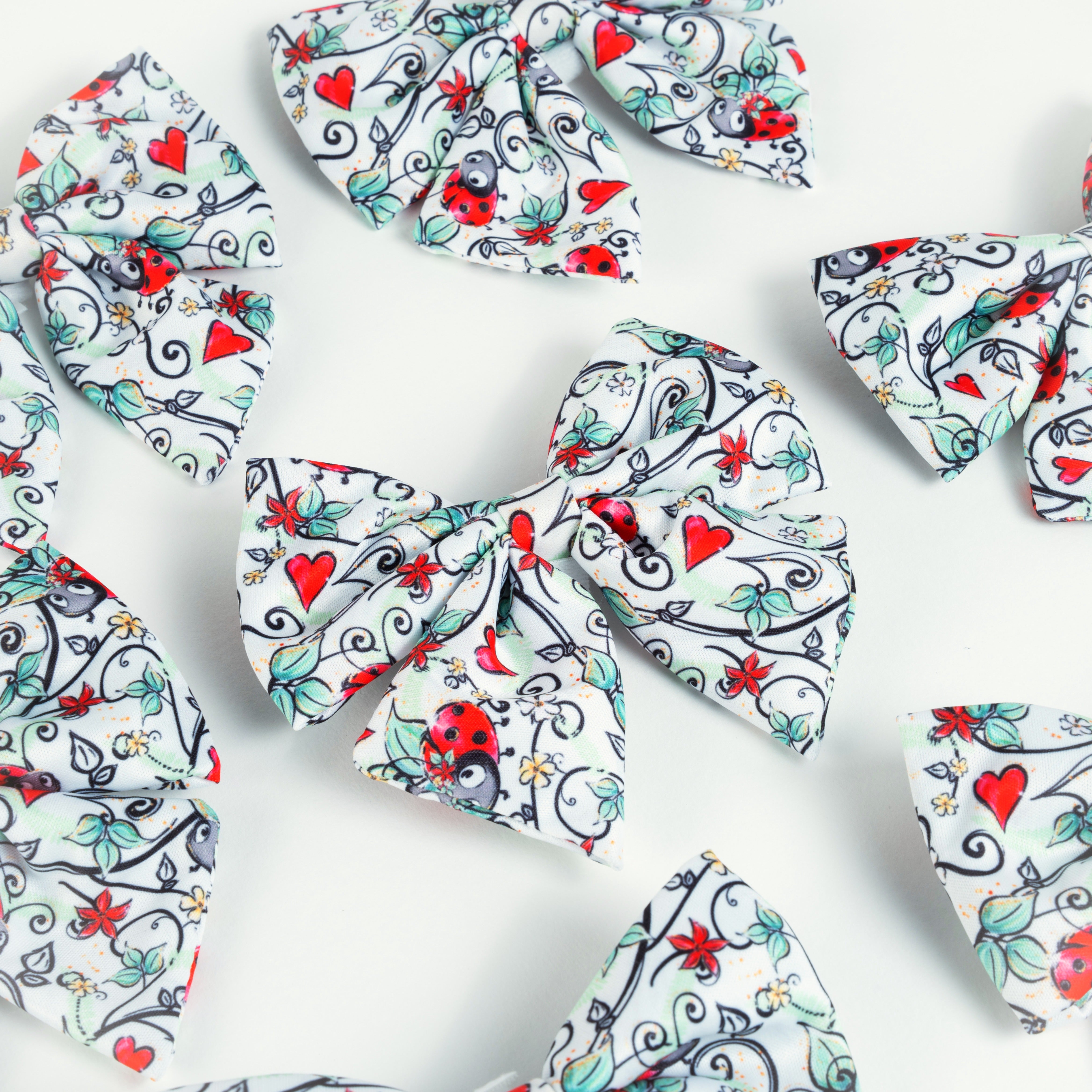 Cute dog bows with ladybug, heart, and floral patterns for stylish puppy accessories