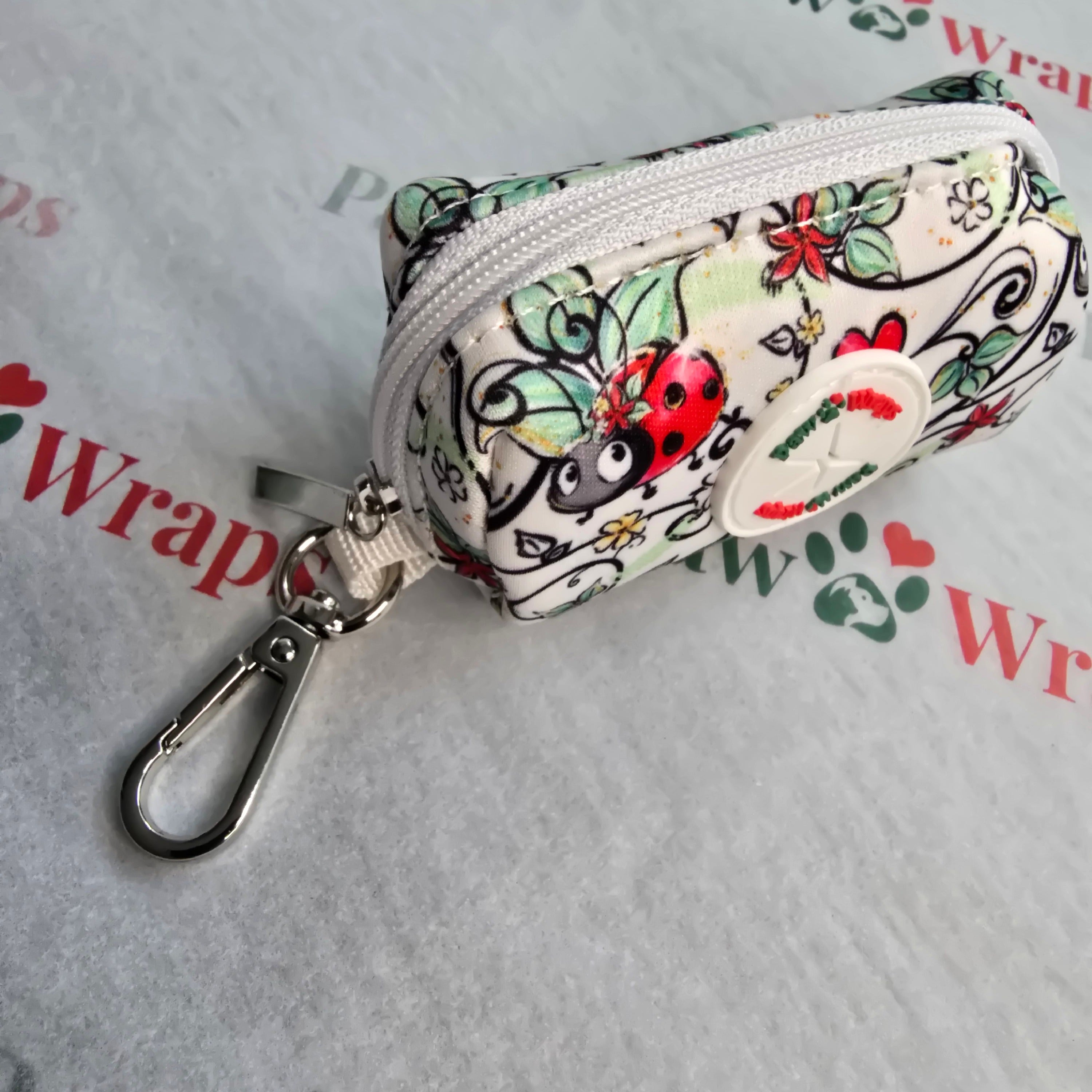 Floral ladybug dog accessory pouch with carabiner clip, perfect for stylish walks