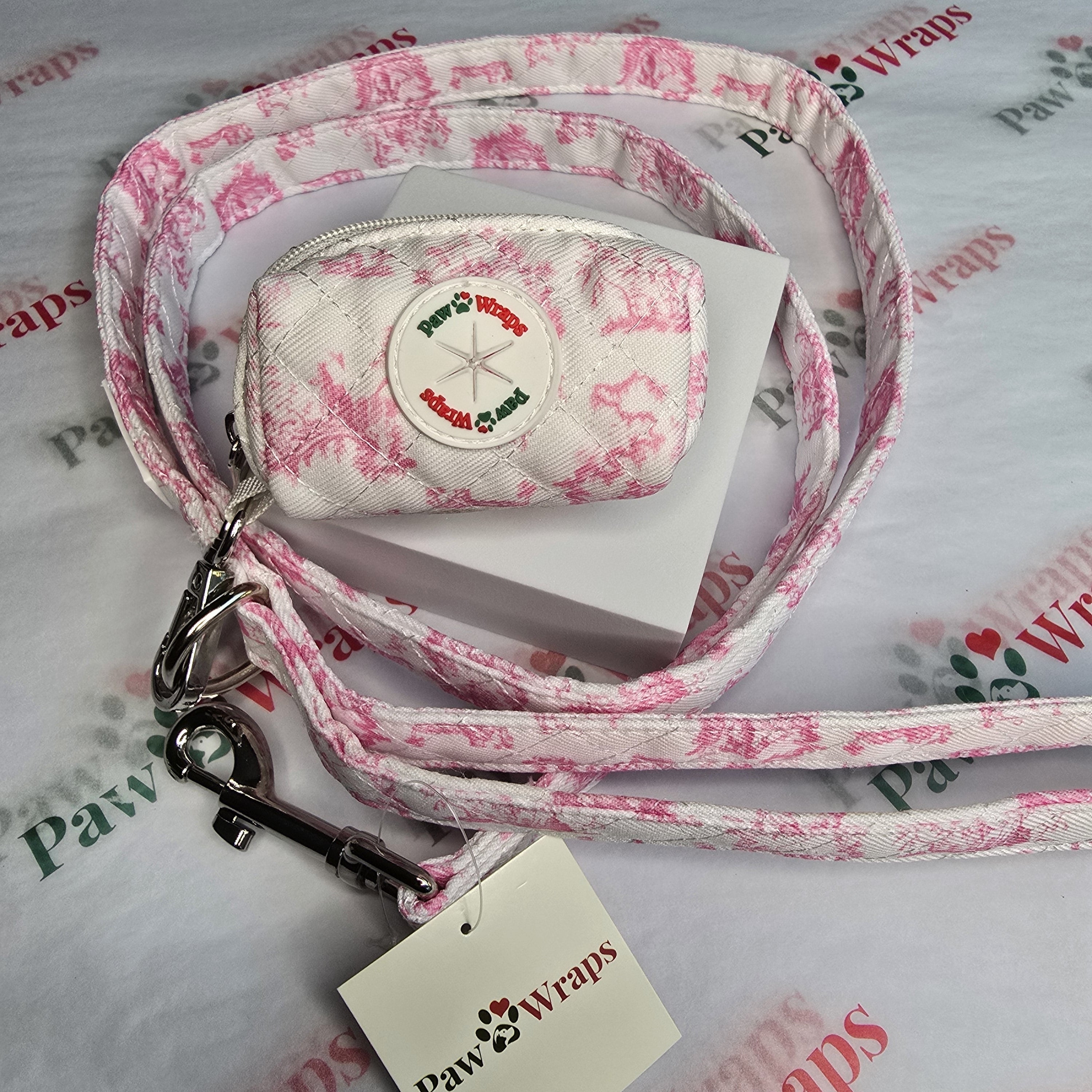Pink floral dog leash and matching pouch with Paw Wraps branding, stylish pet accessory set