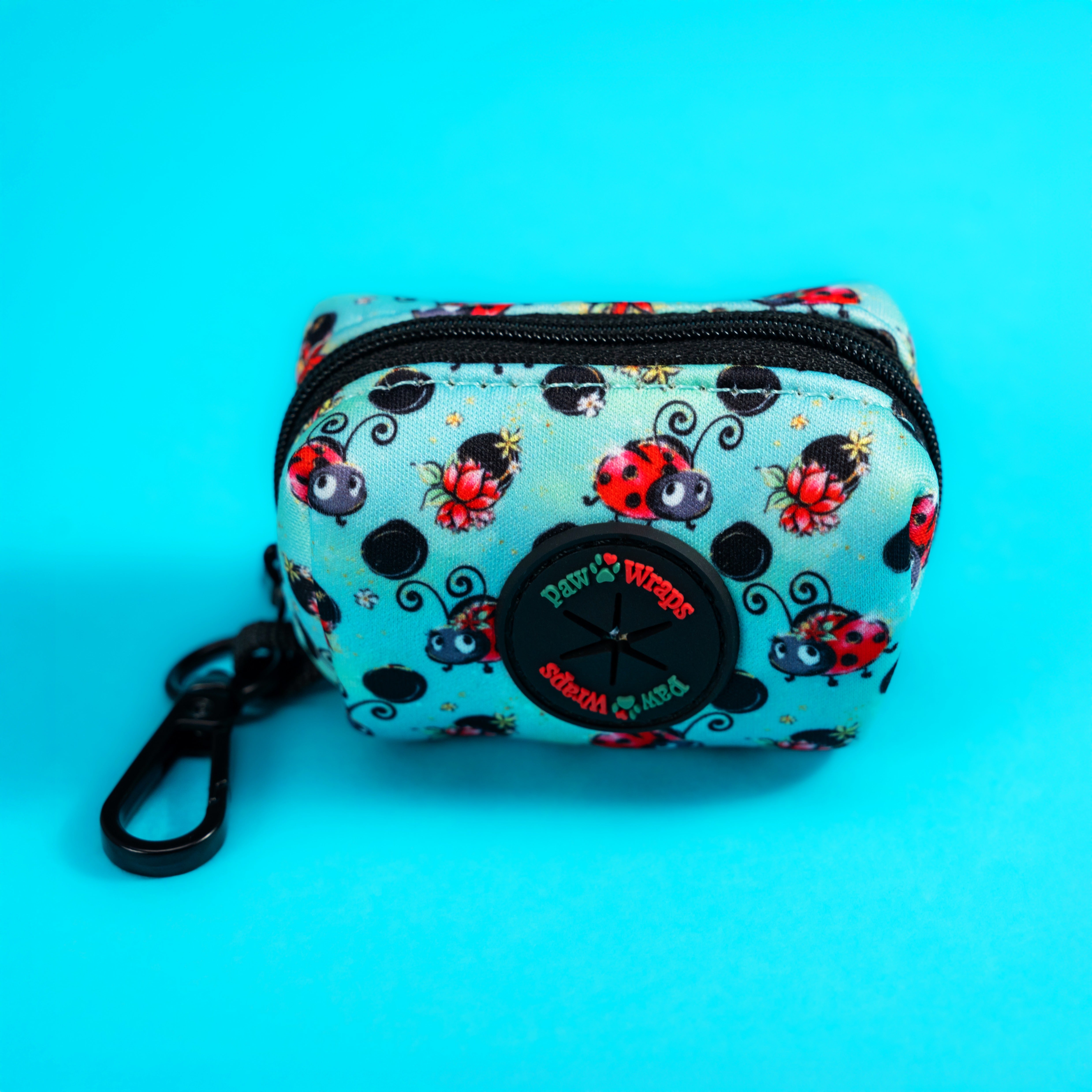 Cute ladybug print dog accessory pouch with black zipper and clip, perfect for stylish walks.