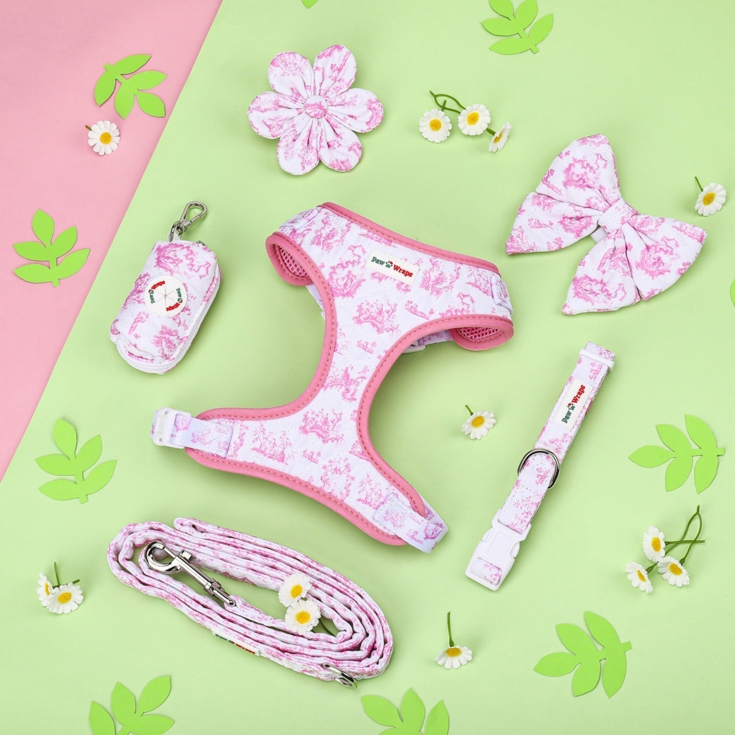 Pink floral dog harness set with matching leash, bow, and waste bag holder on pastel background